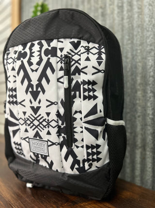 Backpack with black and white geometric pattern on a wooden surface