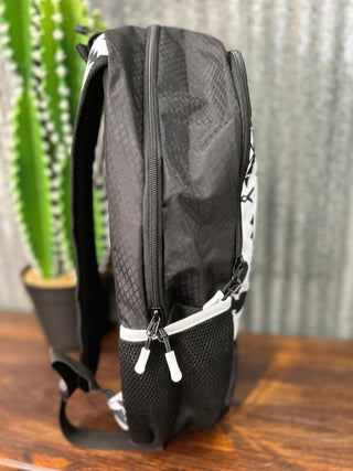 Black mesh backpack with white zippers on a wooden surface with a plant in the background
