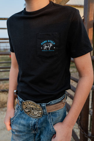 Person wearing a black t-shirt with a logo and blue jeans with a large belt buckle.