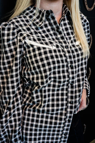 Black and white checkered shirt worn by a person with a blurred background