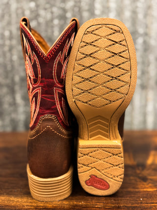 Brown cowboy boot with red accents and a close-up of the sole on a wooden surface.