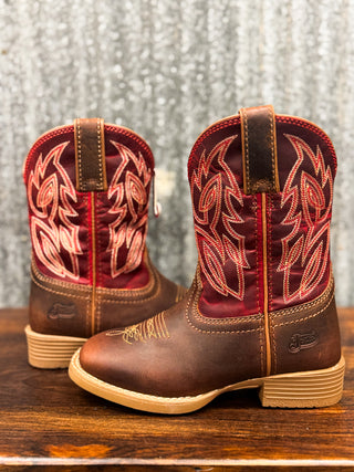 Pair of brown and red cowboy boots with intricate stitching on a wooden surface.