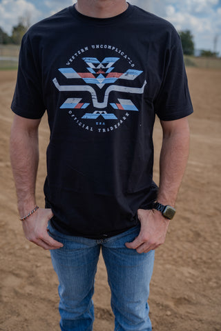 Person wearing a black t-shirt with a logo in an outdoor setting