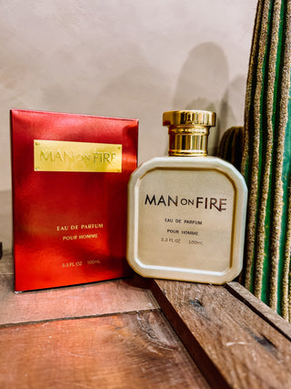Man on Fire perfume bottle and packaging on a wooden surface