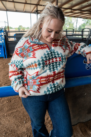 Woman wearing a patterned sweater in an indoor setting