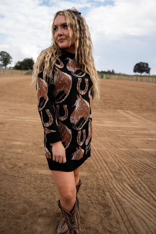 Woman wearing a black dress with horse print in an outdoor setting