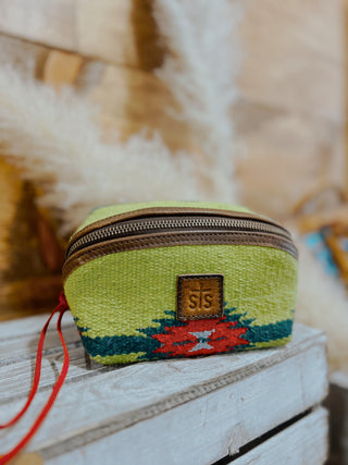 Green woven pouch with a zipper and visible brand logo on a textured surface.