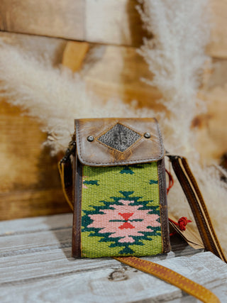 Small pouch with green patterned fabric on a textured surface