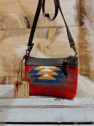 Handbag with a geometric pattern on a wooden surface