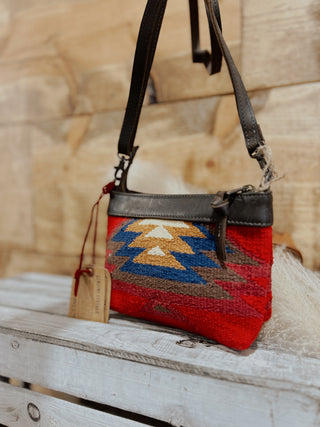 Handbag with a colorful pattern on a wooden surface