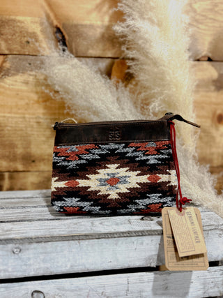 Woven pouch with geometric pattern on a wooden surface