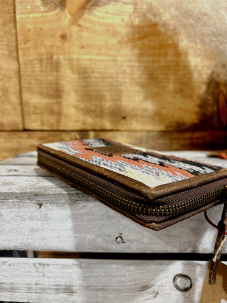 Woven pouch with geometric pattern on a wooden surface