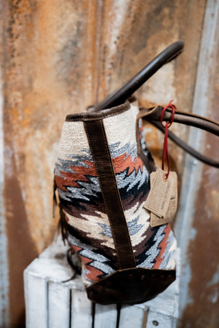 Patterned bag with a tag on a wooden surface