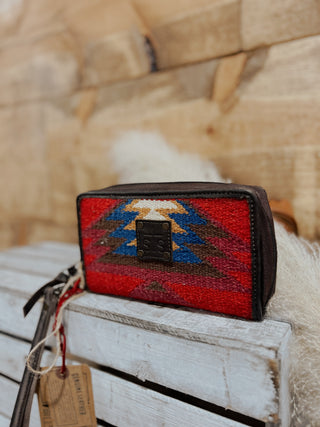 Woven clutch with geometric pattern on a wooden surface