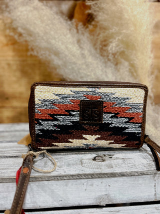 Woven wallet with geometric pattern on a wooden surface