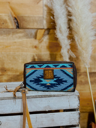 Handbag with blue geometric pattern on a wooden surface