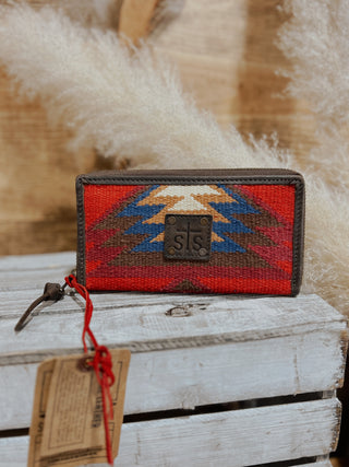 Woven wallet with geometric pattern on a wooden surface