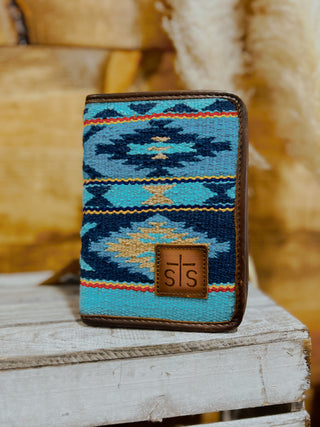 Phone case with blue and brown pattern on a wooden surface