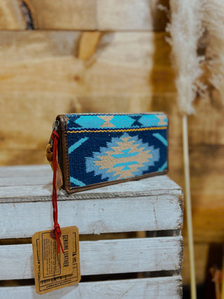 Woven pouch with geometric pattern on a wooden surface