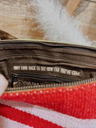 Close-up of a zipper with text on a fabric background