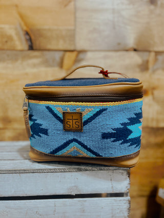 Blue patterned bag with brown accents on a wooden surface