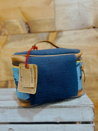 Blue fabric bag with a tag on a wooden surface