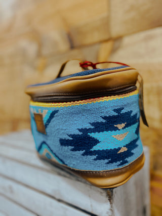 Blue and brown patterned pouch on a wooden surface