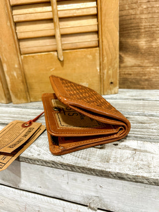Brown leather wallet with a tag on a wooden surface
