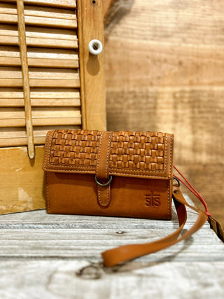 Brown woven leather wallet with strap on a wooden surface