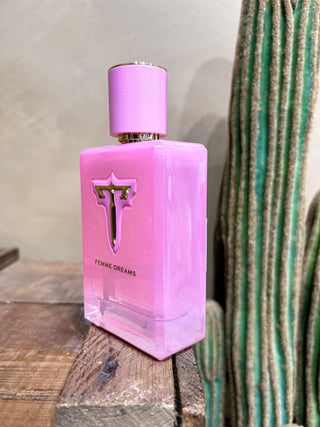 Pink perfume bottle with a cactus in the background