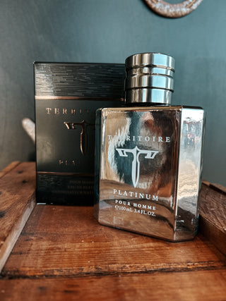 Perfume bottle and packaging on a wooden surface with a dark background