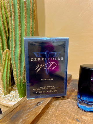 Territoire pour homme perfume bottle and packaging on a wooden surface with a cactus in the background