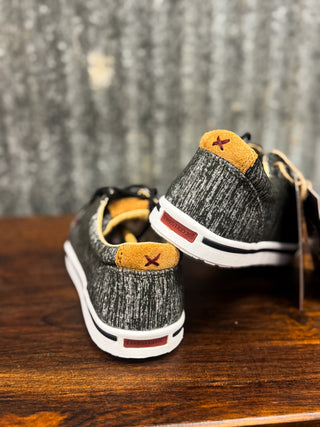 Pair of gray sneakers with orange accents on a wooden surface