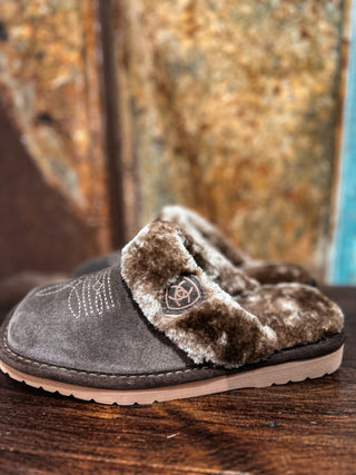 Pair of gray slippers with brown fur trim on a wooden surface.