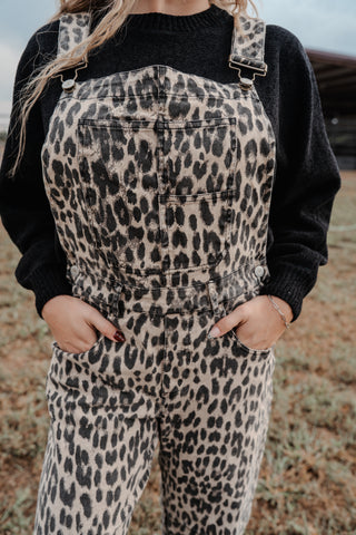 Person wearing leopard print overalls with a black top in an outdoor setting