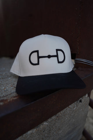 White object with a black symbol on a dark background