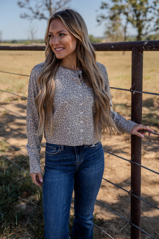 Woman standing by a fence in a rural setting
