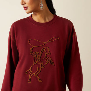 Maroon sweatshirt with embroidered horse and rider design on a beige background