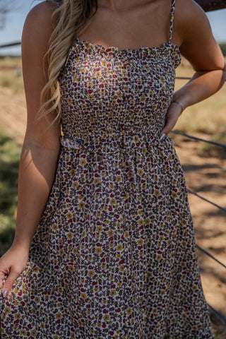Woman wearing a floral dress in an outdoor setting