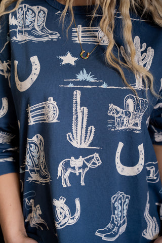 Navy blue shirt with white western-themed pattern worn by a person