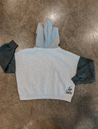 Gray hoodie with a logo on a brown surface