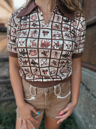 Person wearing a patterned shirt with cowboy graphics and shorts.