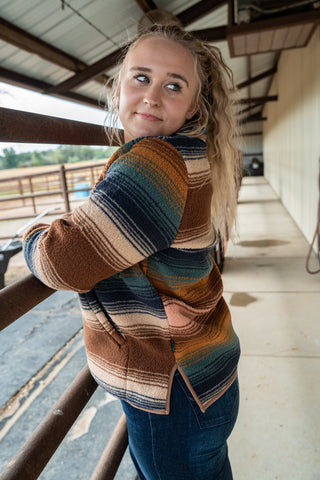Woman wearing a striped sweater in an indoor setting