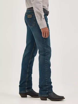 Person wearing blue jeans and black boots on a white background