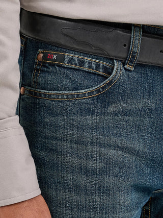 Close-up of blue jeans with a belt and visible brand logo.