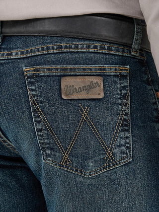 Close-up of a blue denim pocket with a Wrangler logo on a person wearing jeans.