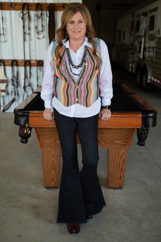 Woman standing behind a pool table in an indoor setting