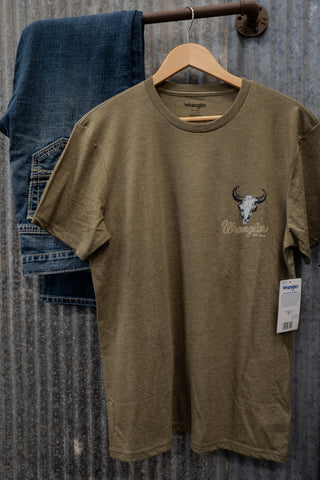 Olive green t-shirt with a logo on a hanger against a textured wall.