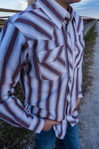 Person wearing a striped shirt with a blurred background