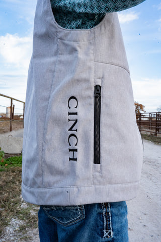 Gray Cinch vest with a blue patterned interior worn by a person outdoors.